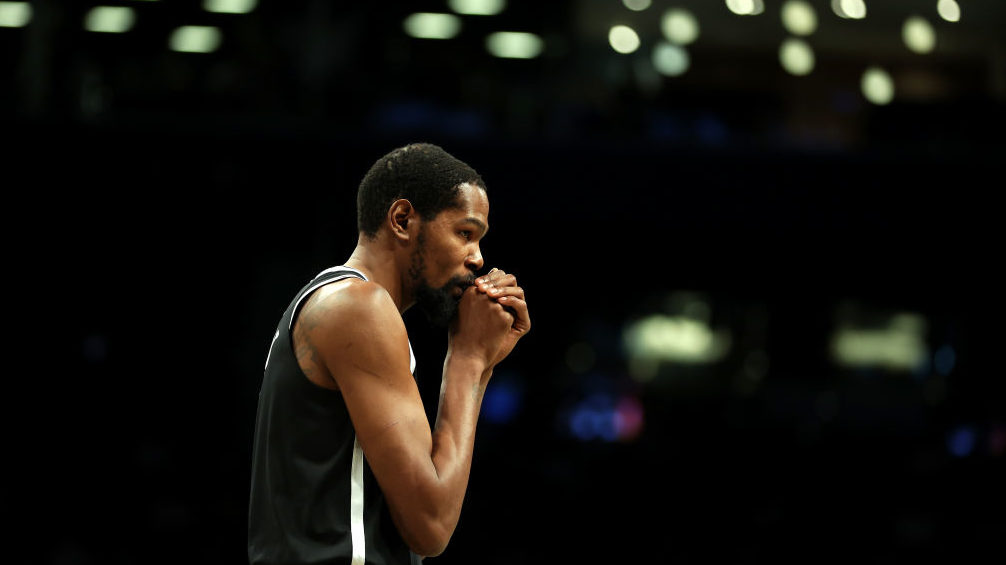 Kevin Durant #7 of the Brooklyn Nets looks on against the Golden State Warriors during the first ha...