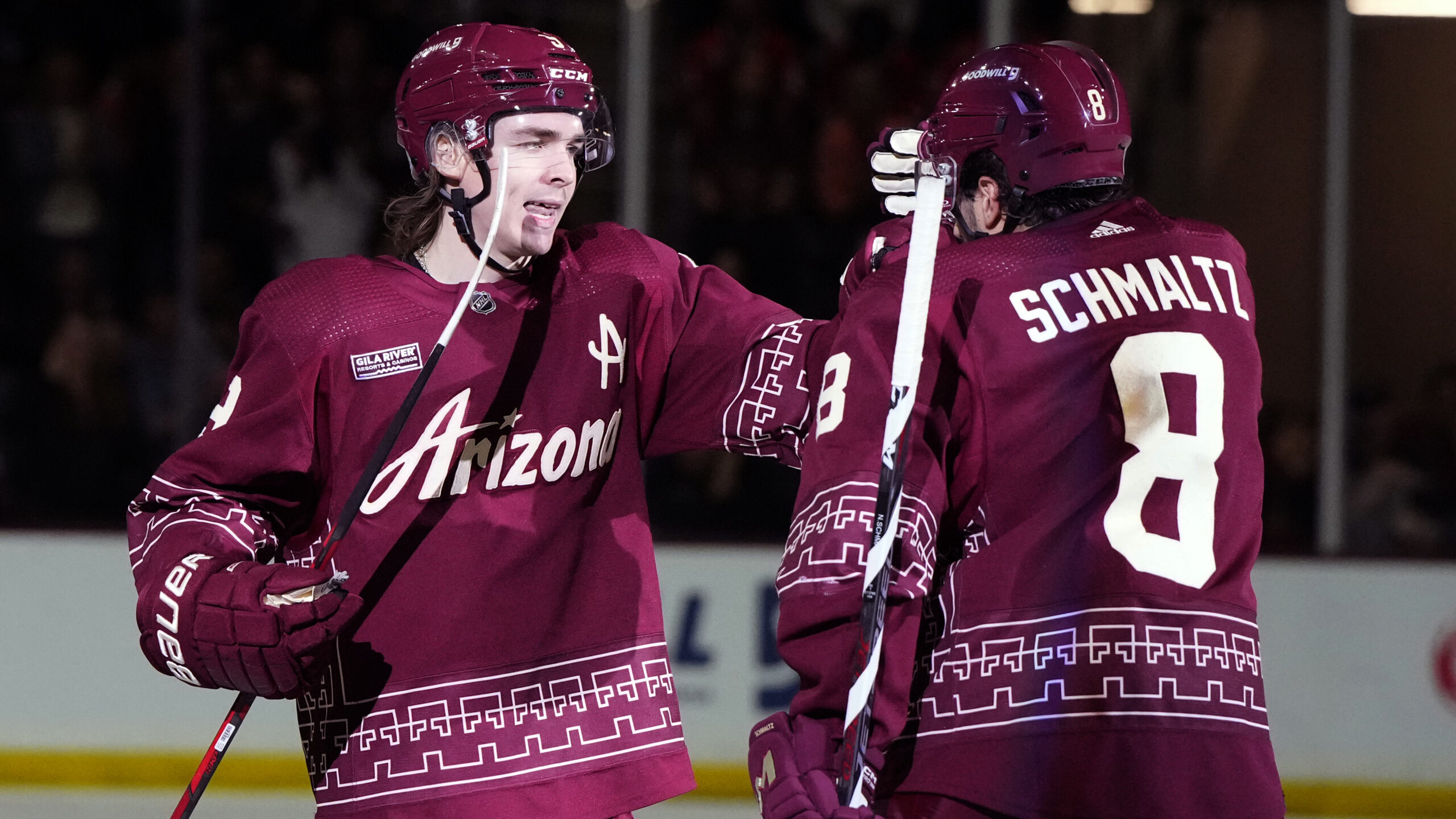 Arizona Coyotes right wing Clayton Keller celebrates with center Nick Schmaltz (8) after scoring a ...