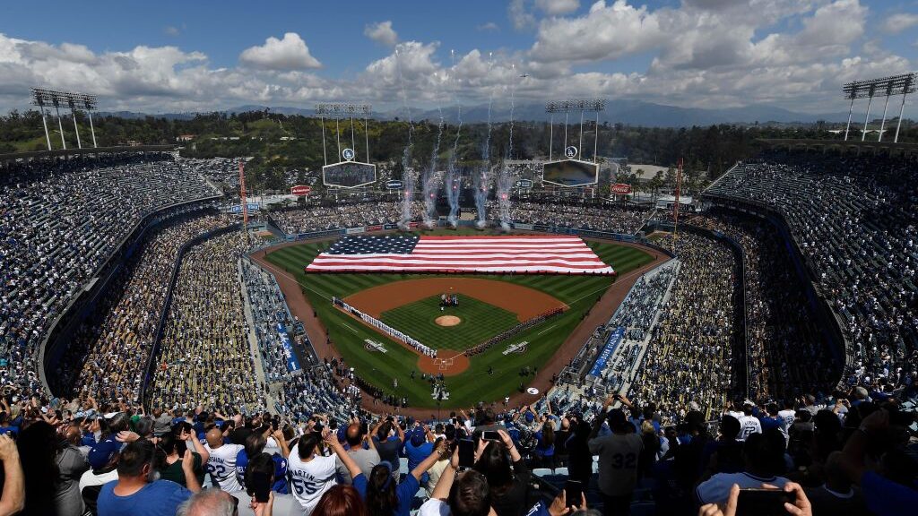 Fans cheer for an Opening Day baseball game between Arizona Diamondbacks and Los Angeles Dodgers at...