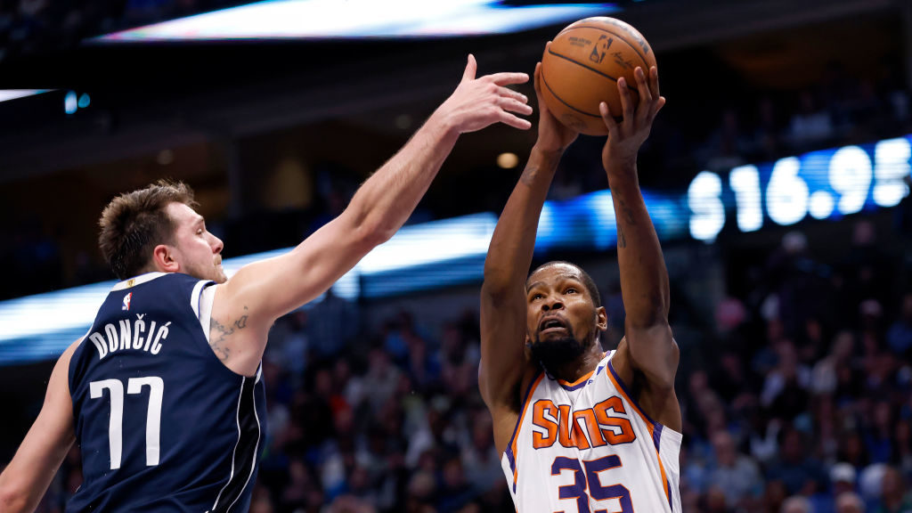 Kevin Durant #35 of the Phoenix Suns goes to the basket as Luka Doncic #77 of the Dallas Mavericks ...