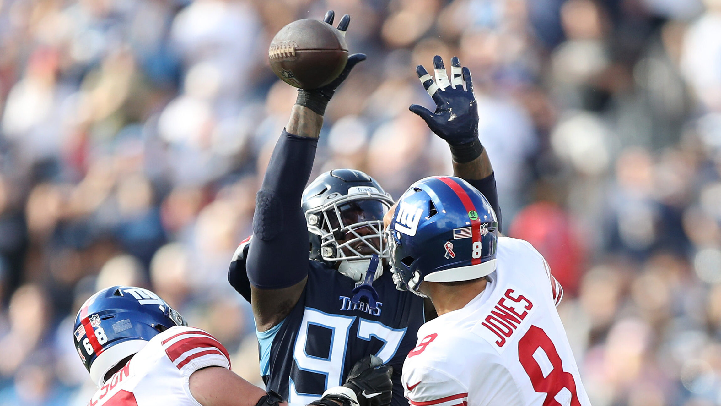 Defensive end Kevin Strong #97 of the Tennessee Titans knocks down a pass from quarterback Daniel J...