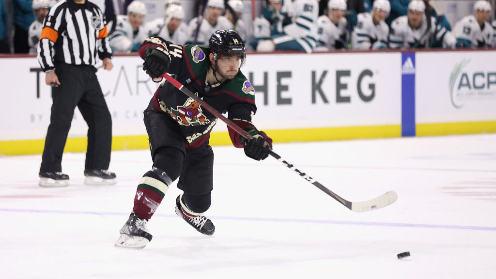 Shayne Gostisbehere #14 of the Arizona Coyotes passes the puck during the NHL game at Mullett Arena...