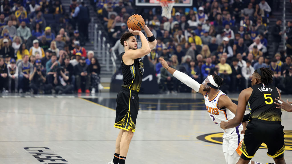 Klay Thompson #11 of the Golden State Warriors shoots a three-point basket over Josh Okogie #2 of t...