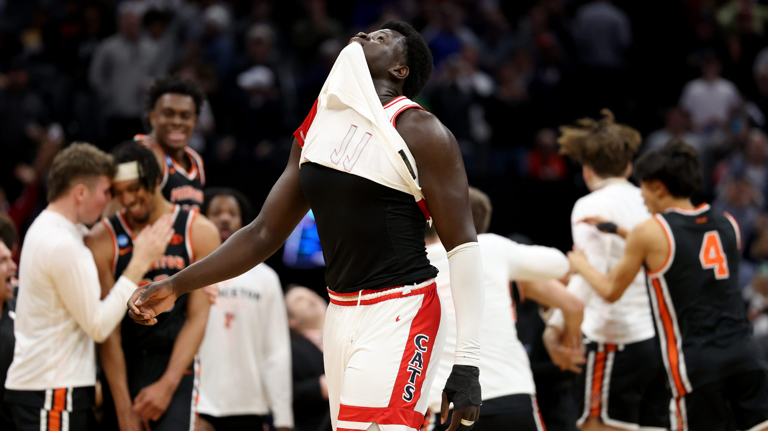 Oumar Ballo #11 of the Arizona Wildcats reacts as the Princeton Tigers celebrate after defeating th...