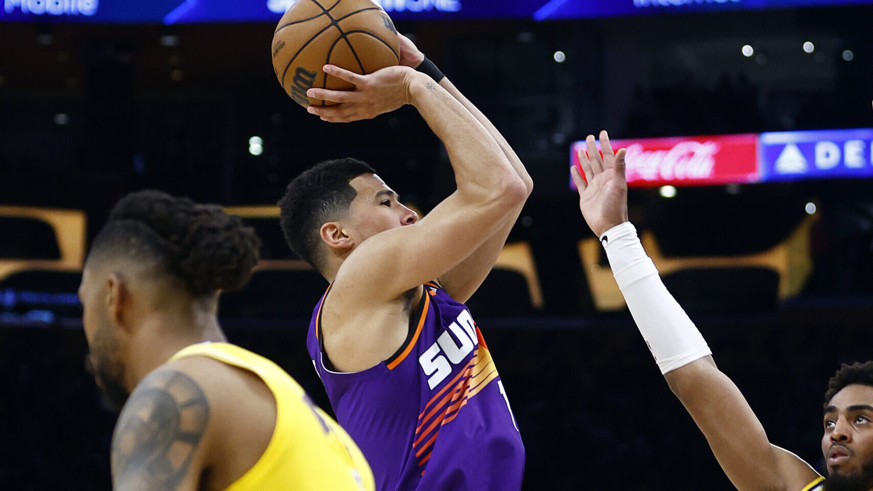 Devin Booker #1 of the Phoenix Suns takes a shot against the Los Angeles Lakers in the second half ...