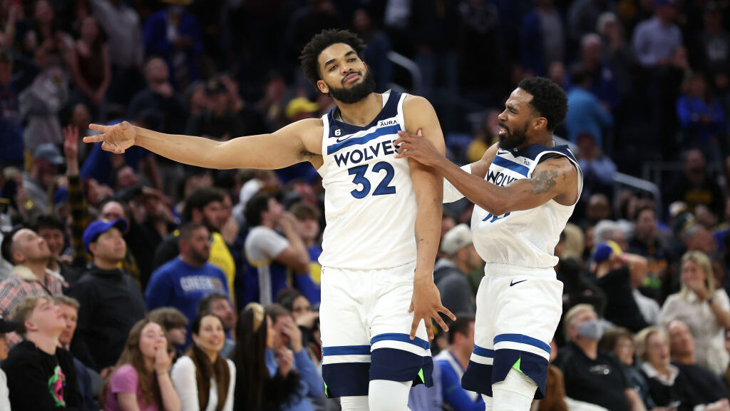 Karl-Anthony Towns #32and Mike Conley #10 of the Minnesota Timberwolves react after Towns hit the g...