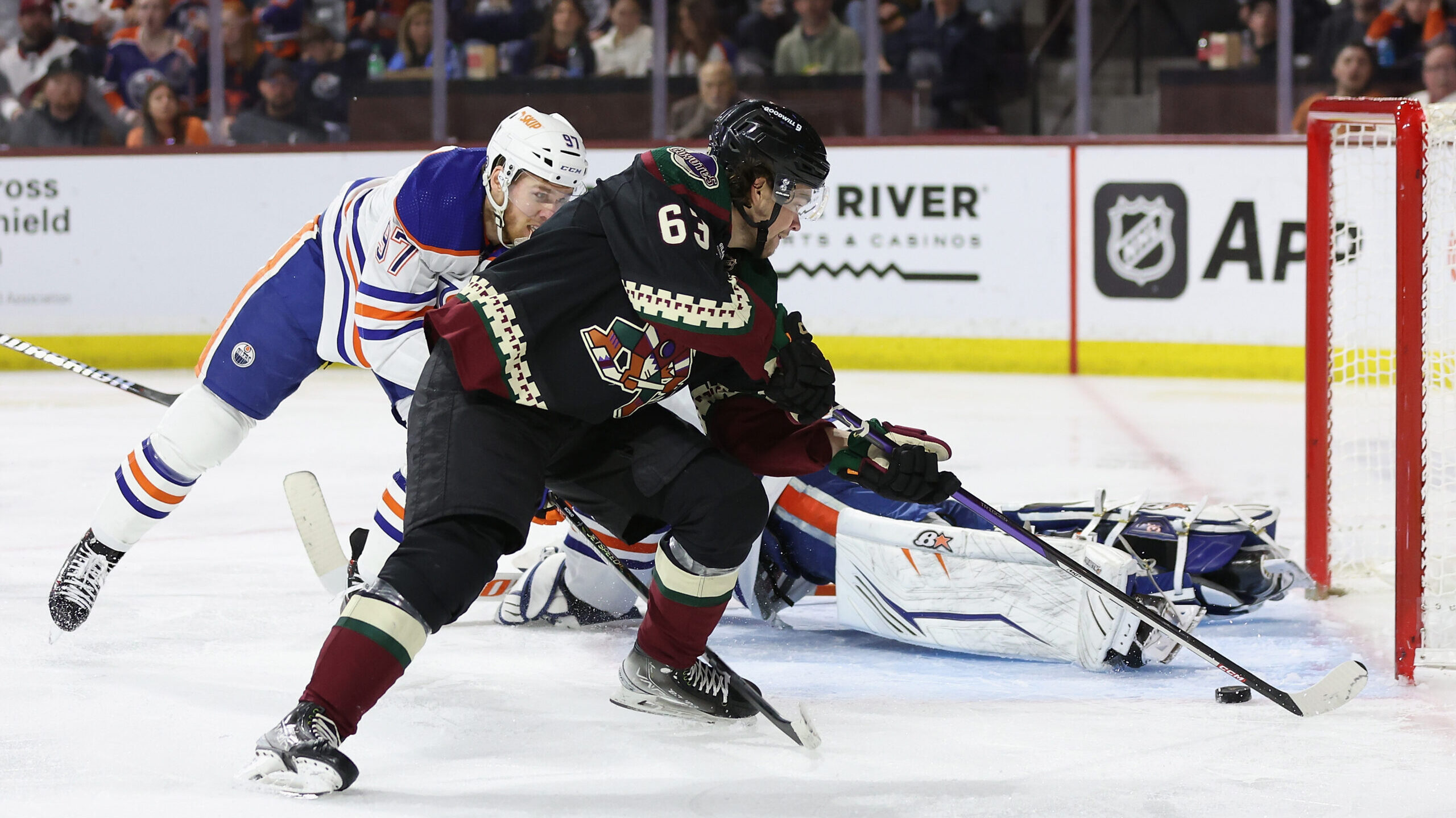 Matias Maccelli #63 of the Arizona Coyotes shoots to score a goal past goaltender Jack Campbell #36...
