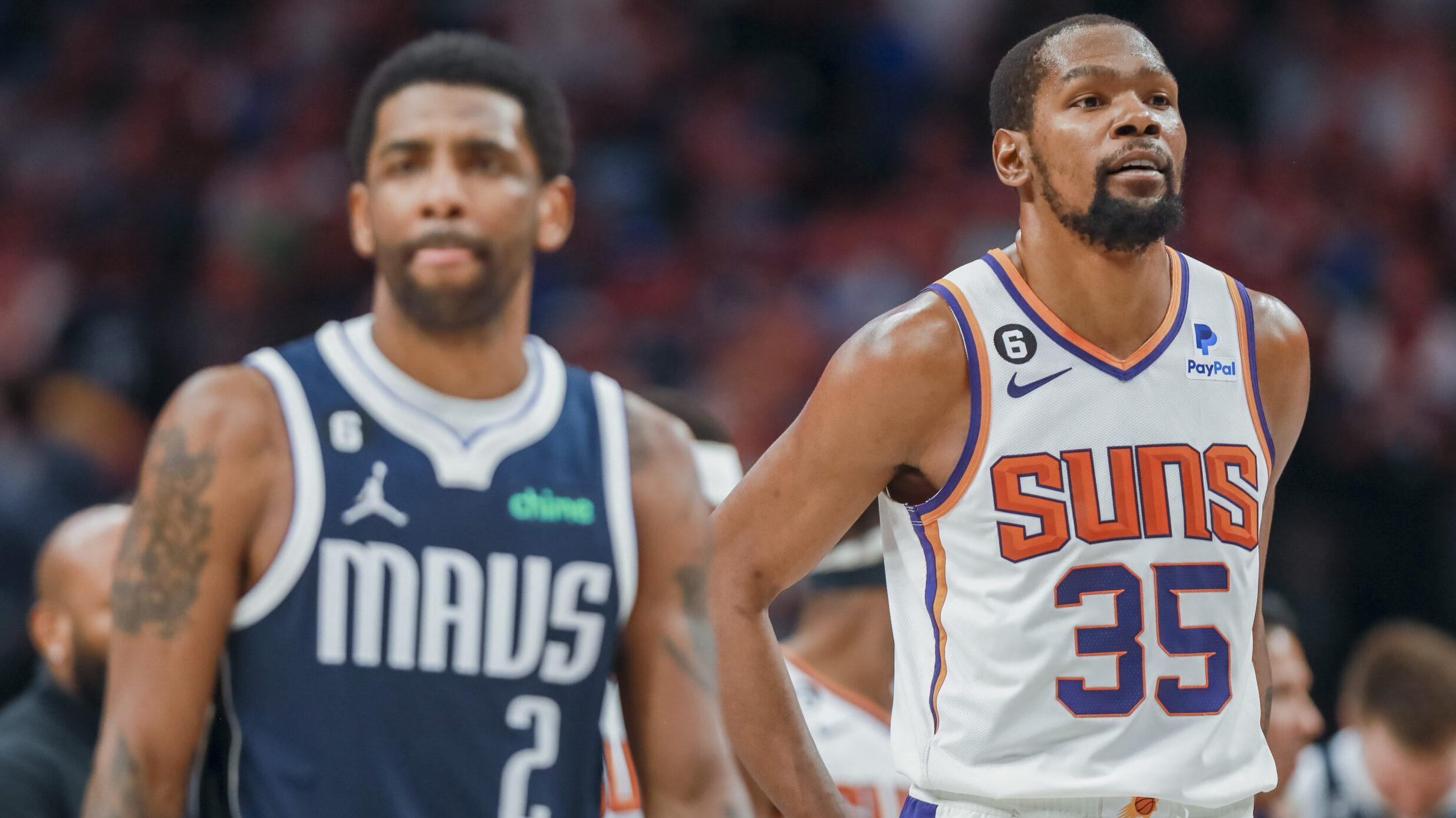 Dallas Mavericks guard Kyrie Irving (2) and Phoenix Suns forward Kevin Durant (35) walk down the co...