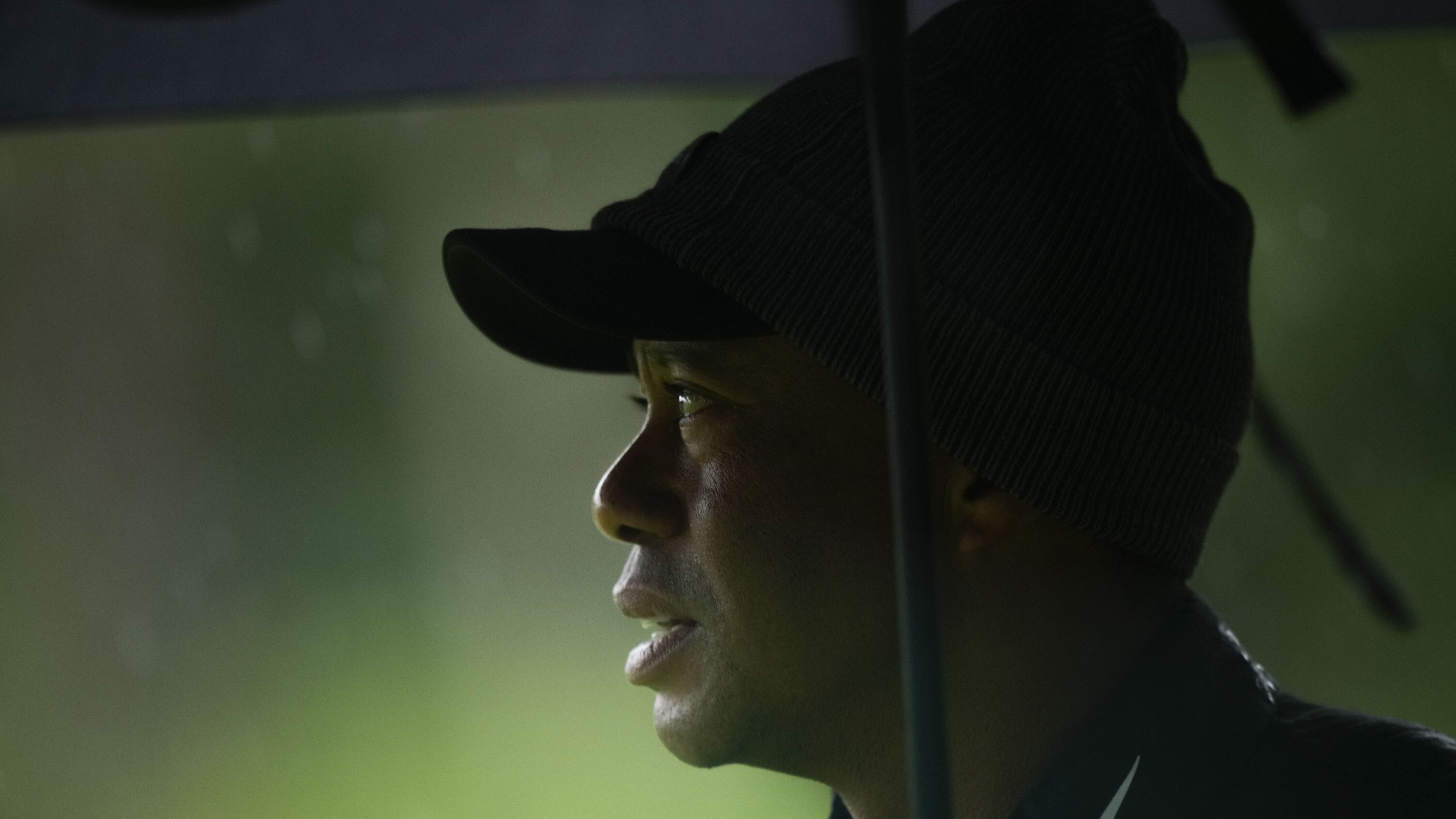 Tiger Woods watches on the 13th hole during the weather delayed third round of the Masters golf tou...