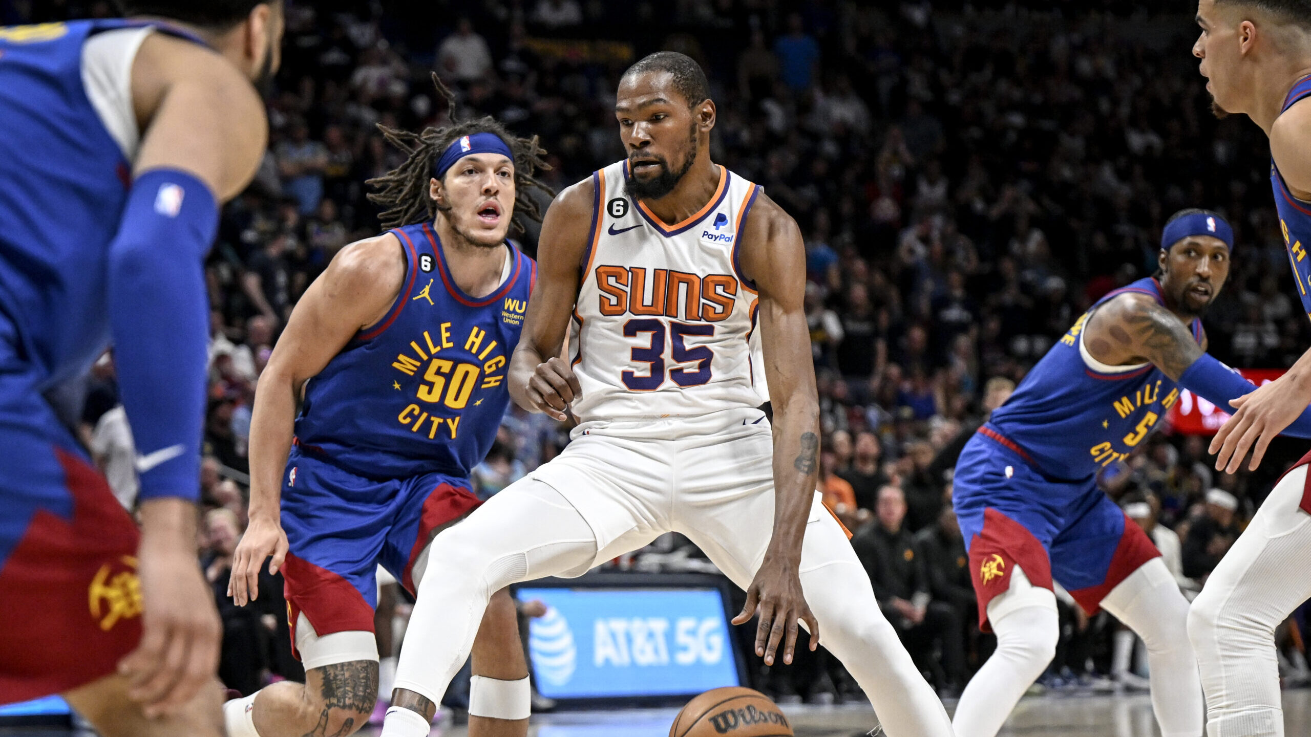 Kevin Durant (35) of the Phoenix Suns dribbles as Aaron Gordon (50) of the Denver Nuggets defends d...