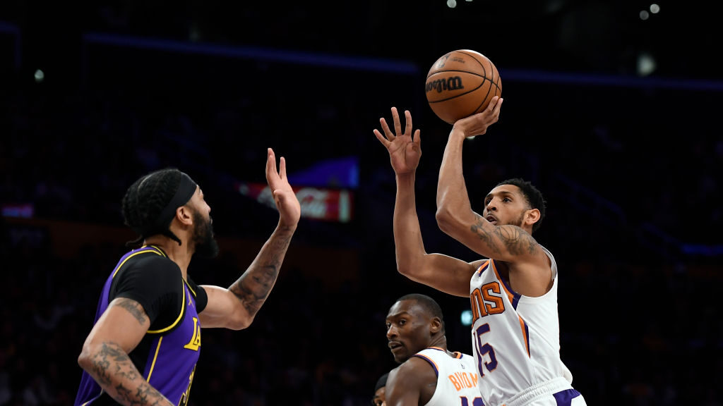 Cameron Payne #15 of the Phoenix Suns score a basket over Anthony Davis #3 of the Los Angeles Laker...