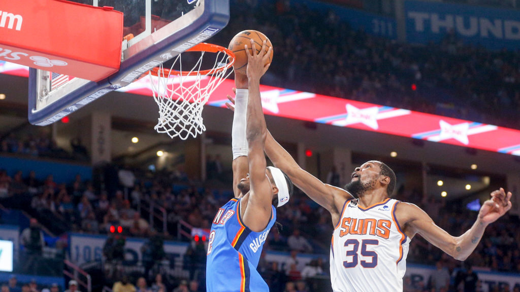Kevin Durant #35 of the Phoenix Suns blocks Shai Gilgeous-Alexander #2 of the Oklahoma City Thunder...