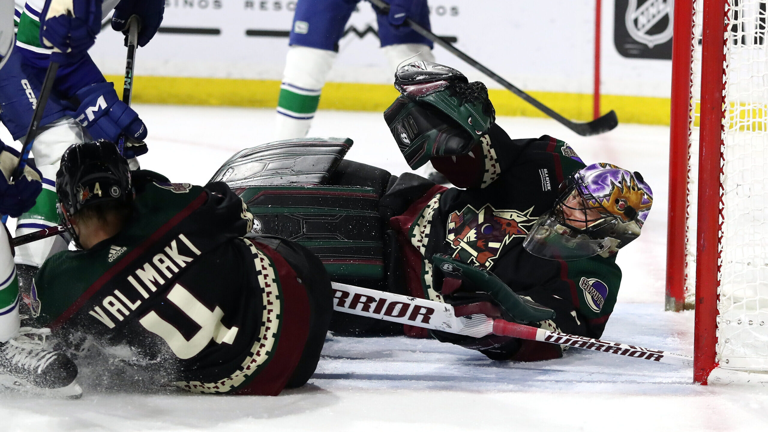 Karel Vejmelka #70 of the Arizona Coyotes makes a save in net against the Vancouver Canucks during ...