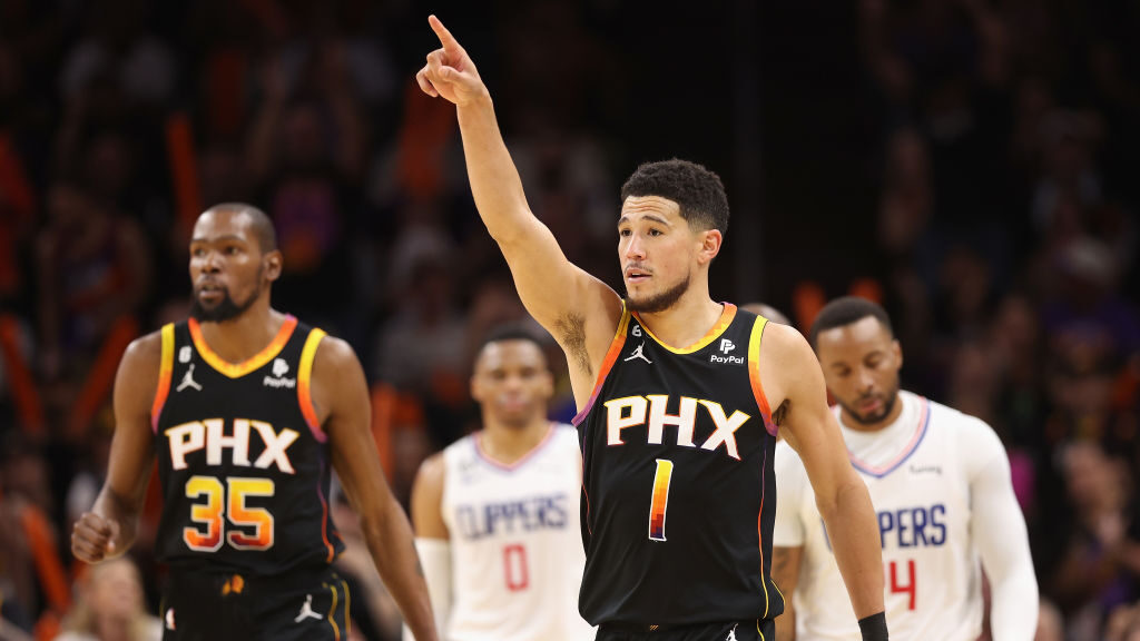 Devin Booker #1 and Kevin Durant #35 of the Phoenix Suns react during the second half of Game Two o...