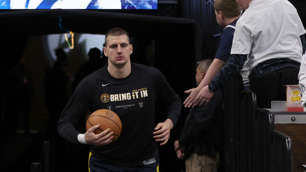 Nikola Jokic #15 of the Denver Nuggets runs on to the court prior to the game against the Minnesota...