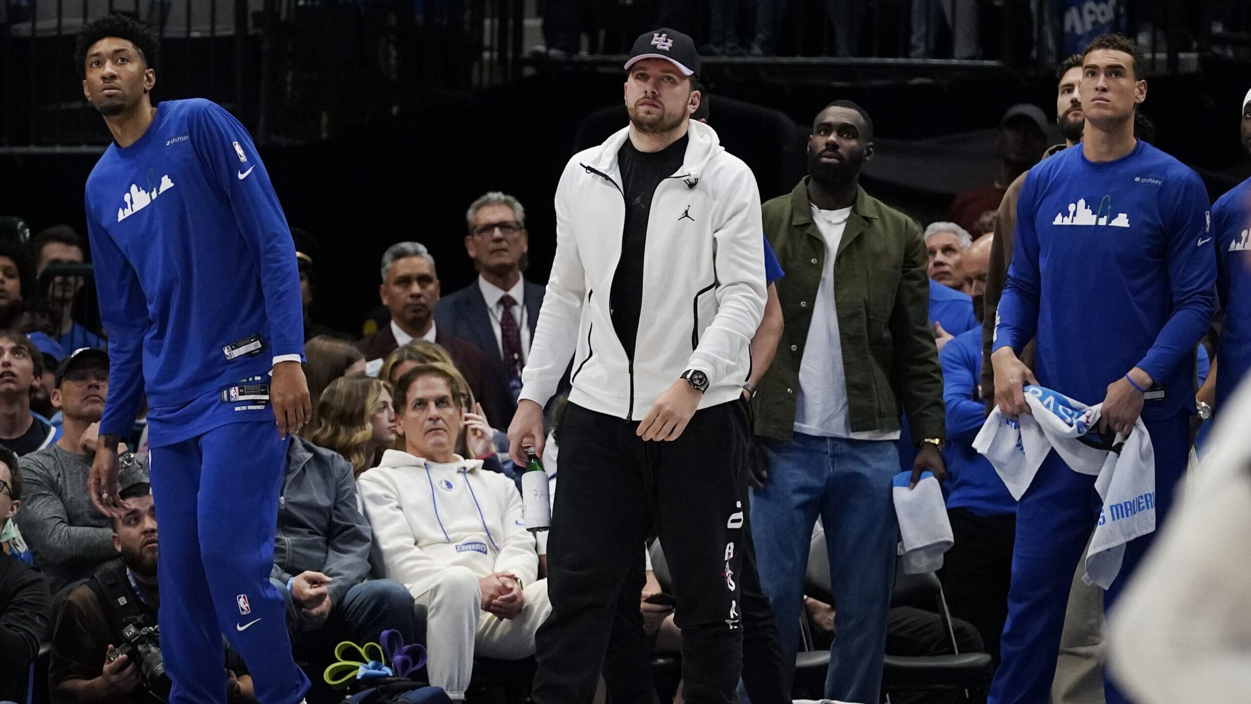 Dallas Mavericks guard Luka Doncic, center, begins to walk off the court with teammates at the end ...
