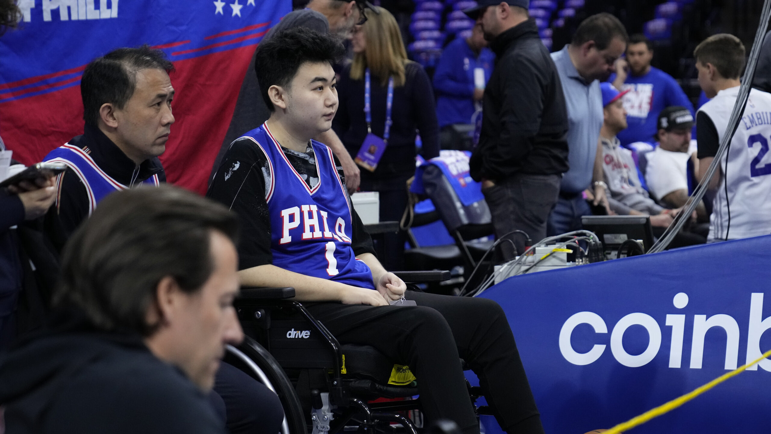 John Hao, second from left, watches warm ups ahead of Game 4 in an NBA basketball Eastern Conferenc...