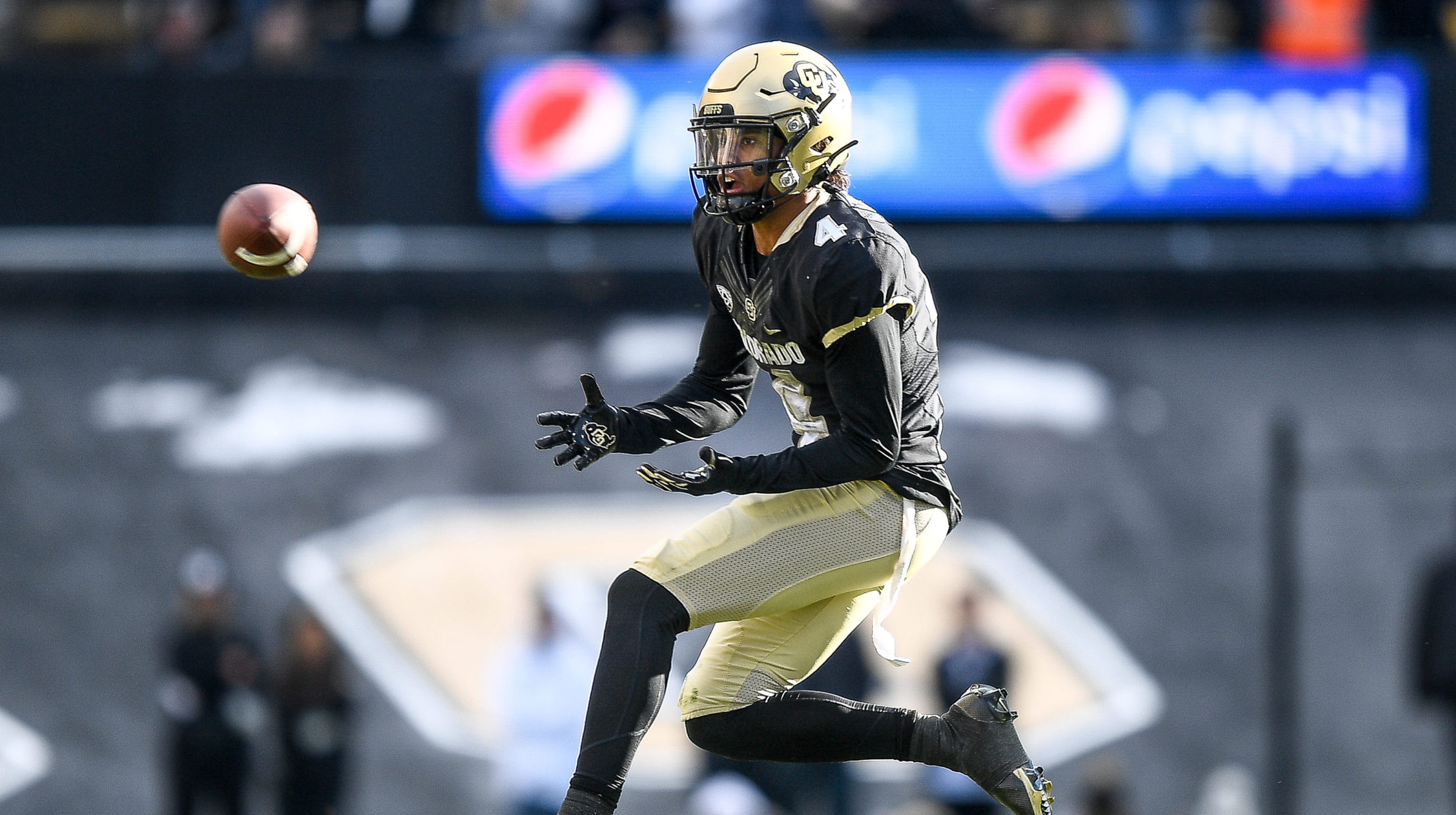 Jordyn Tyson #4 of the Colorado Buffaloes catches a pass in the third quarter of a game against the...