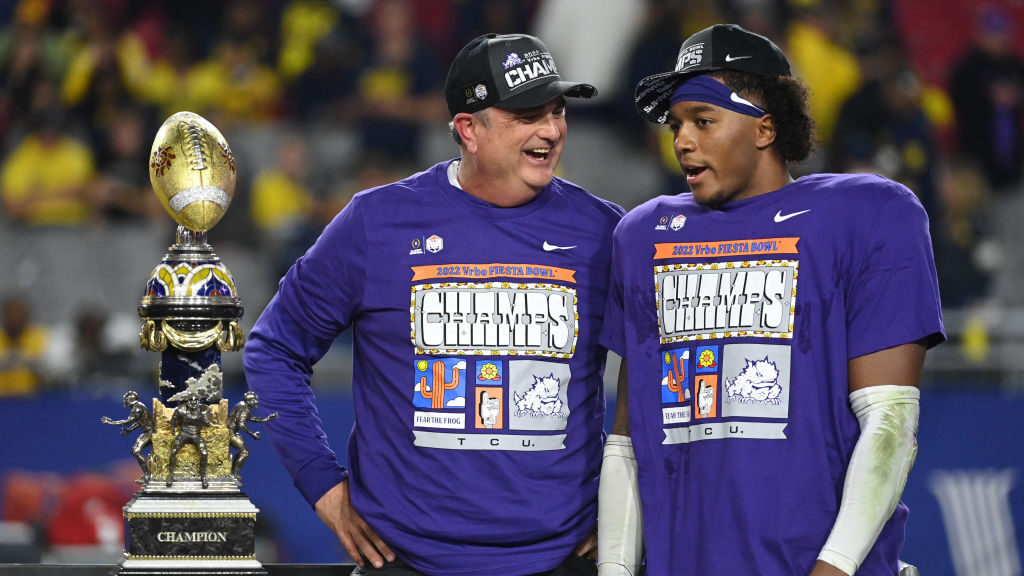 Head coach Sonny Dykes of the TCU Horned Frogs celebrates with the trophy after defeating the Michi...