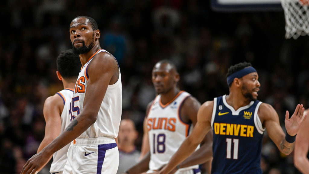Kevin Durant (35) of the Phoenix Suns heads to the foul line as Bruce Brown (11) of the Denver Nugg...