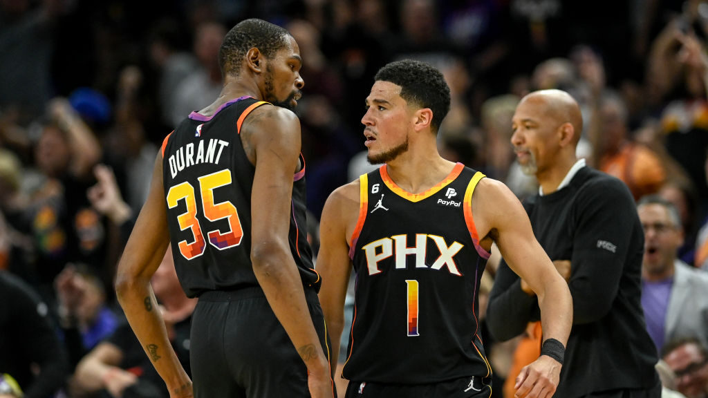 Devin Booker (1) of the Phoenix Suns celebrates with Kevin Durant (35) after hitting a corner three...