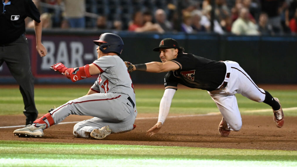 Alex Call #17 of the Washington Nationals is tagged out at third base by Josh Rojas #10 of the Ariz...
