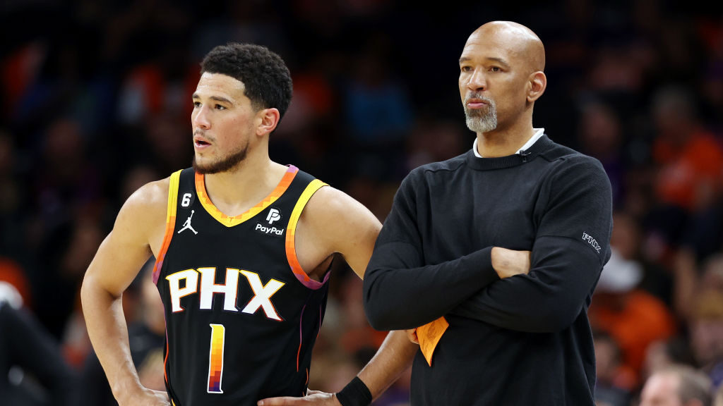 Devin Booker #1 stands with head coach Monty Williams of the Phoenix Suns during the second quarter...