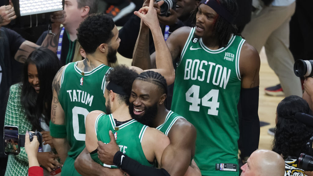 Derrick White #9 and Jaylen Brown #7 of the Boston Celtics react after defeating the Miami Heat 104...