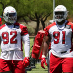 Arizona Cardinals DLs Kevin Strong (left) and L.J. Collier (right) look on during voluntary OTAs on Monday, May 22, 2023, in Tempe. (Tyler Drake/Arizona Sports)