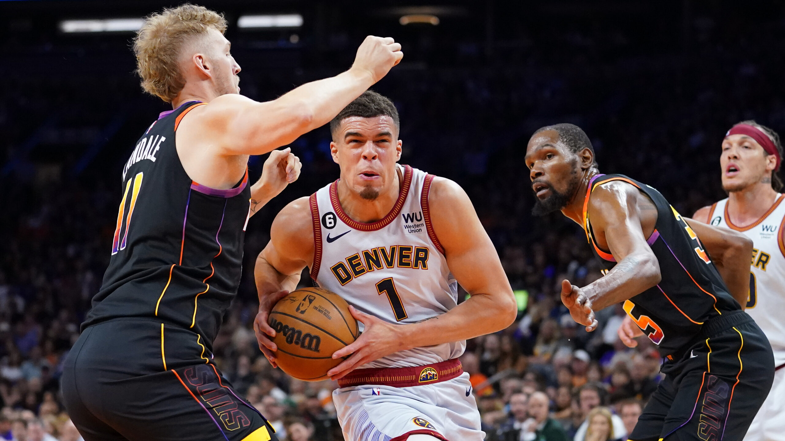 Denver Nuggets forward Michael Porter Jr. (1) drives between Phoenix Suns center Jock Landale, left...