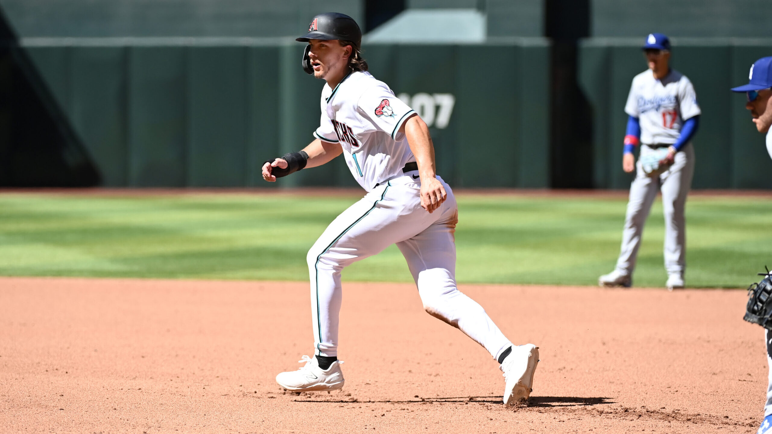 Jake McCarthy #31 of the Arizona Diamondbacks gets a lead from first base against the Los Angeles D...