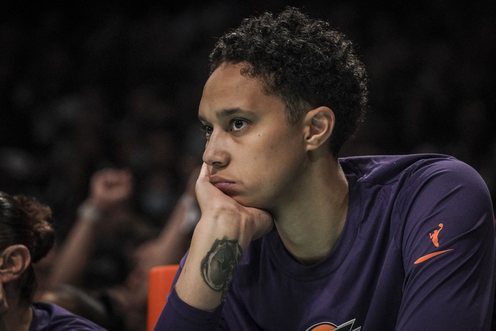 Phoenix Mercury center Brittney Griner watches from the bench during a WNBA basketball game against...