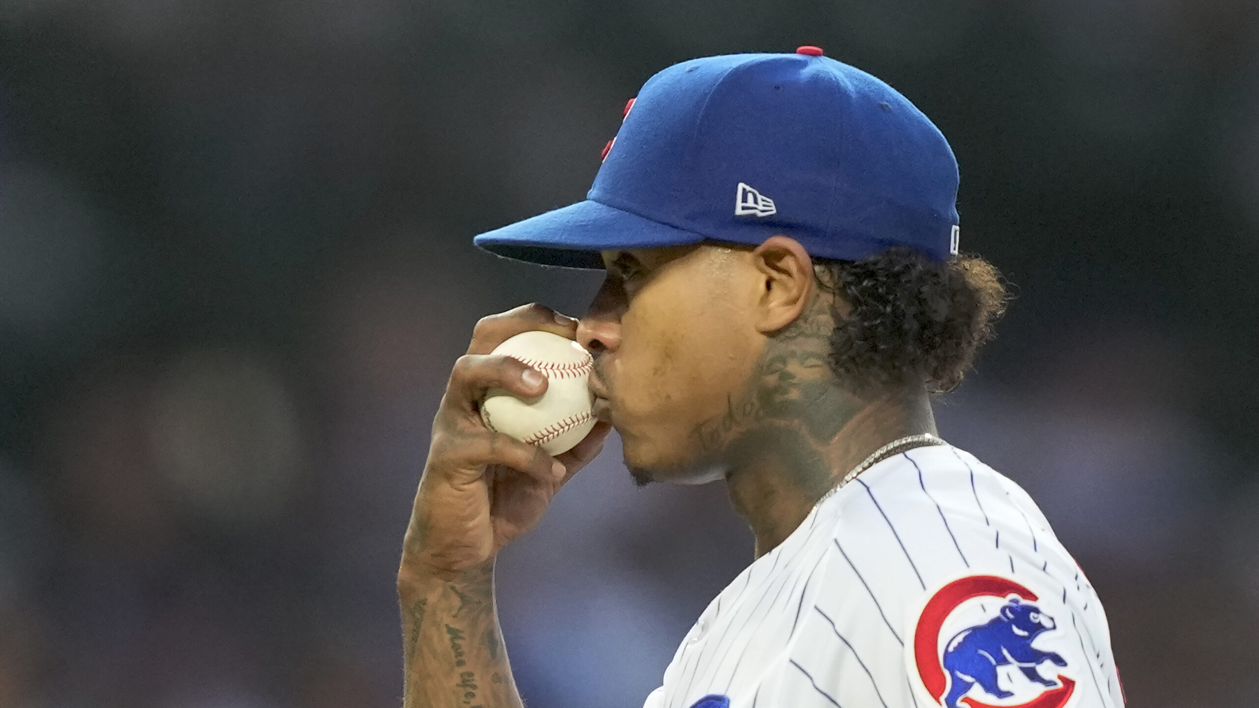 Chicago Cubs' Marcus Stroman kisses the ball before pitching during the fourth inning of the team's...