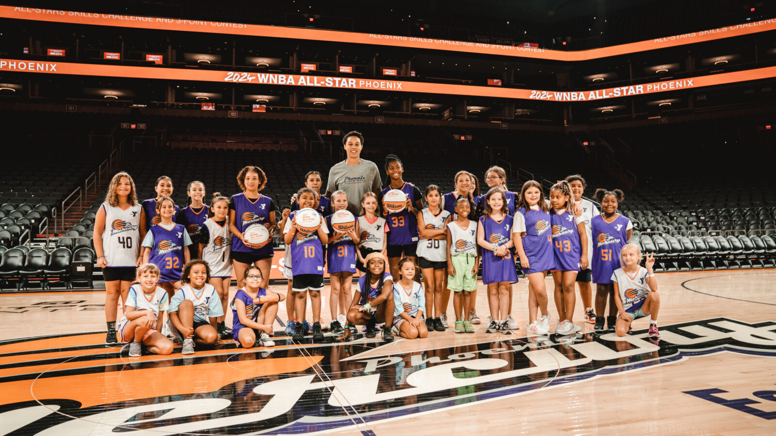 Brittney Griner takes a photo with young athletes from Valley of the Sun YMCA youth basketball and ...