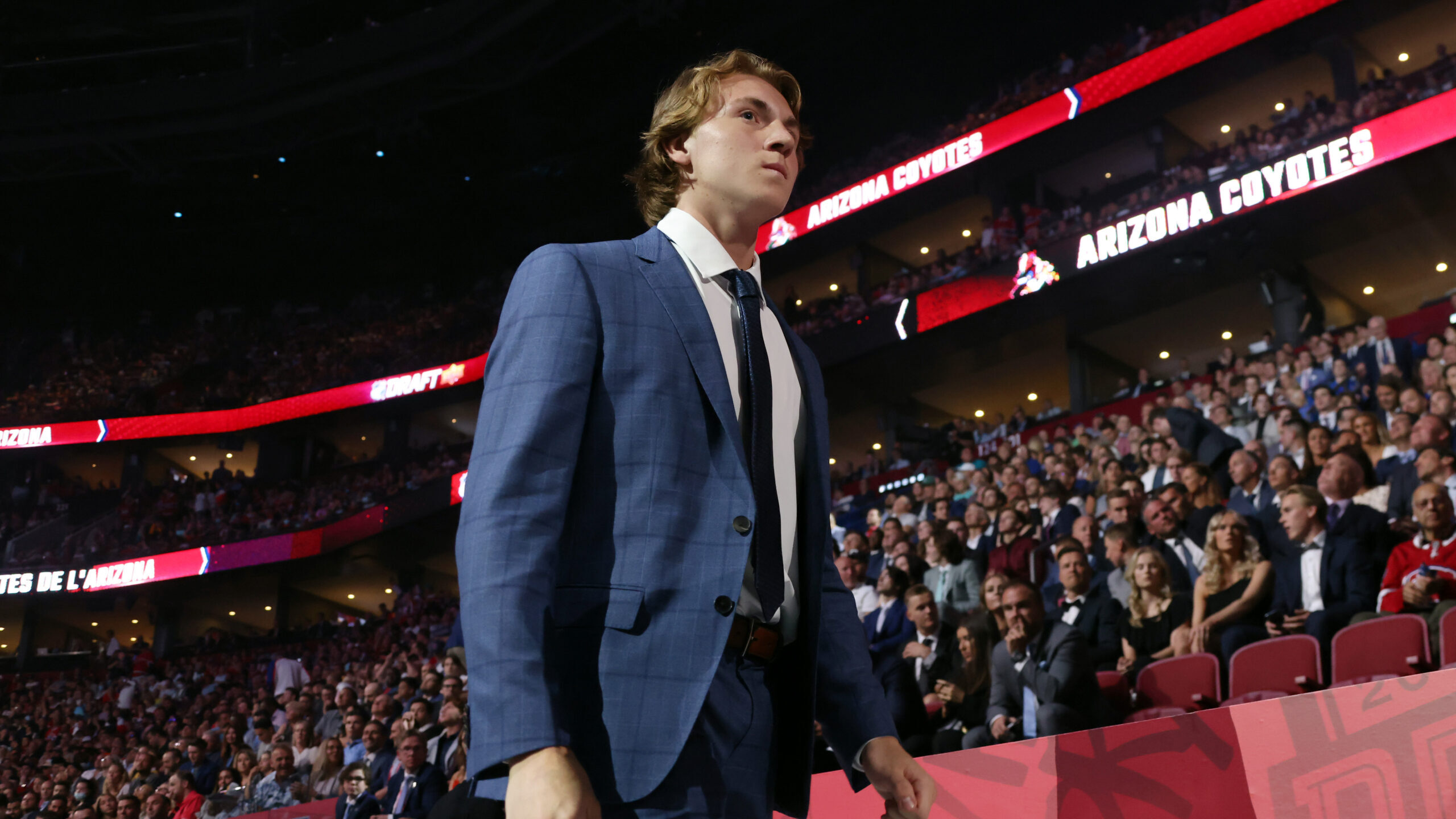 Logan Cooley walks toward the stage after being selected third overall by the Arizona Coyotes durin...