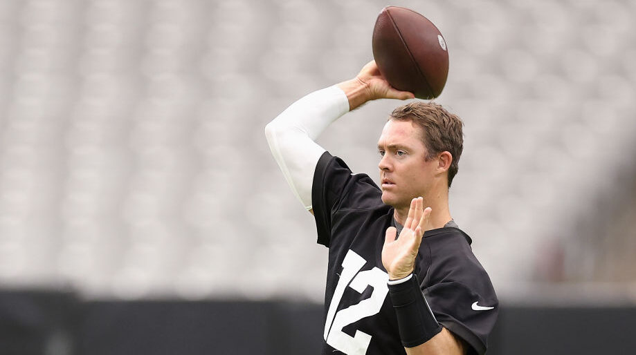 Colt McCoy throws a football during training camp...