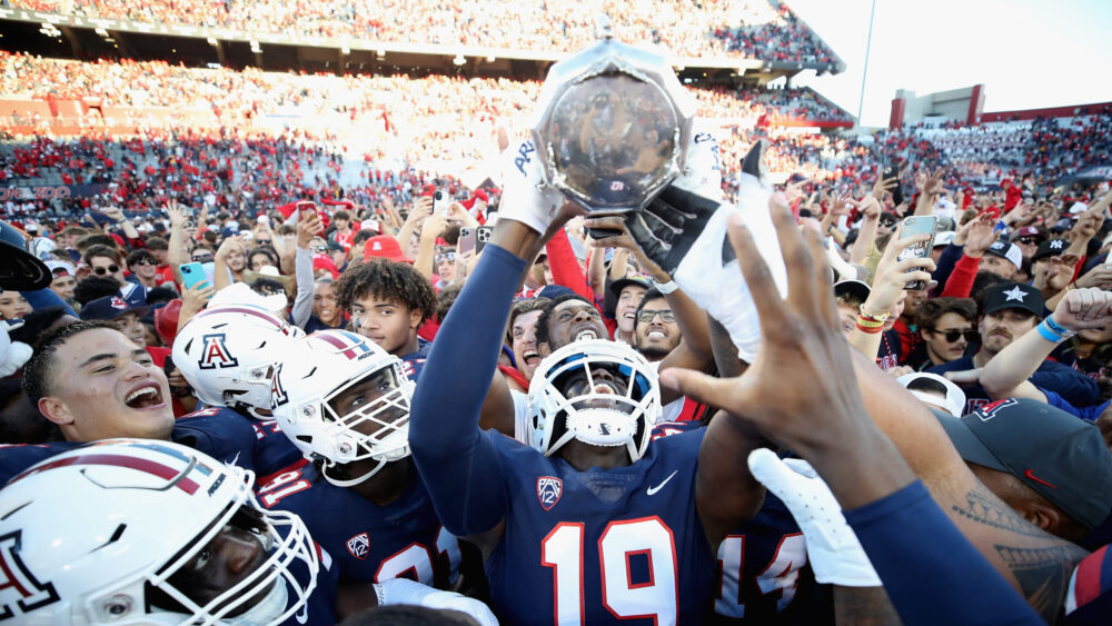 Cornerback Adama Fall #19 of the Arizona Wildcats holds up the Territorial Cup after defeating the ...