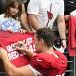Arizona Cardinals TE Bernhard Seikovits signs an autograph during the Red & White practice on Saturday, Aug. 5, 2023, in Glendale. (Tyler Drake/Arizona Sports)