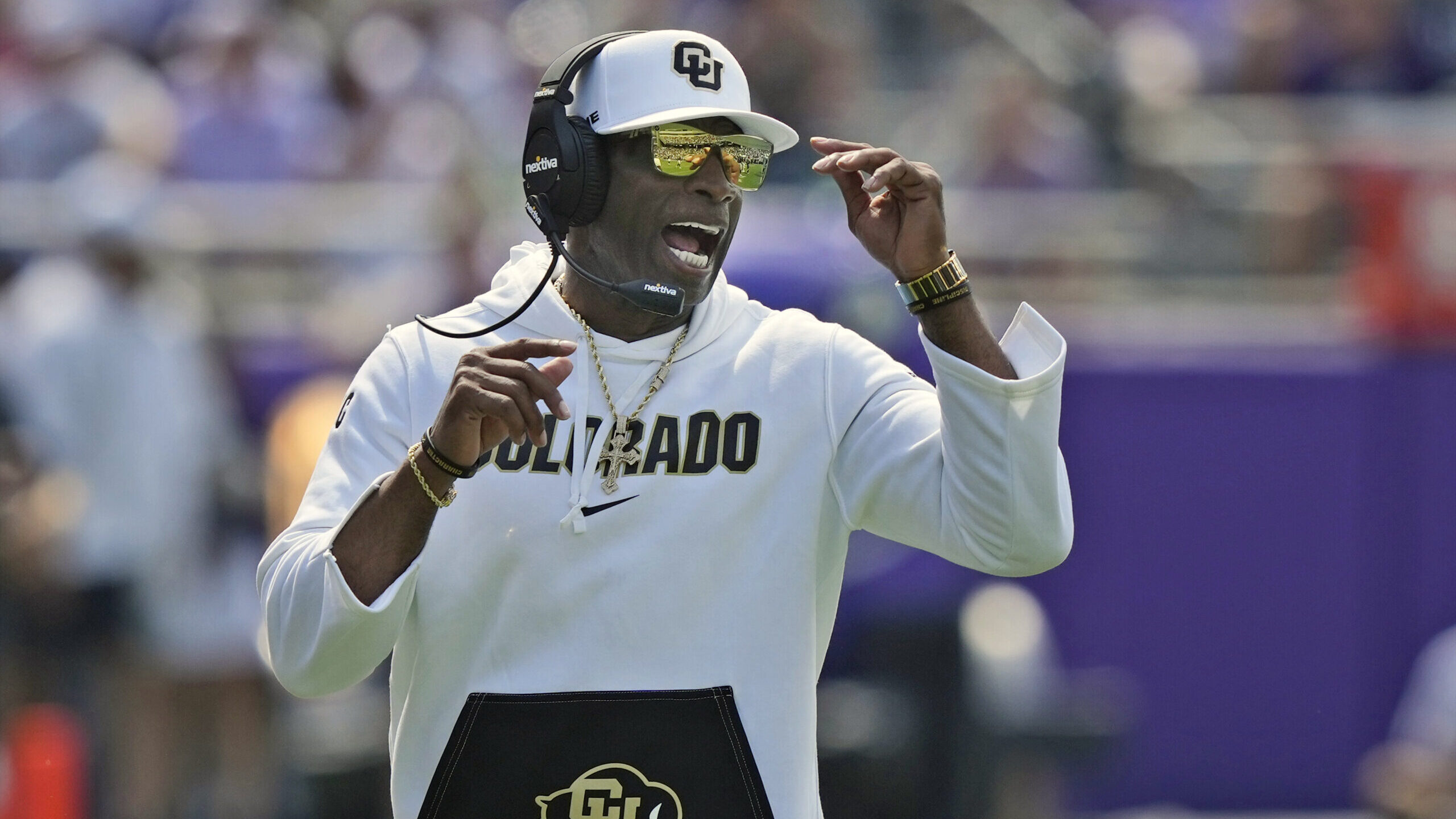 Colorado head coach Deion Sanders yells from the sidelines during the first half of an NCAA college...