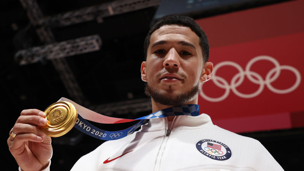 Devin Booker #15 of Team United States poses with his gold medal during the Men's Basketball medal ...