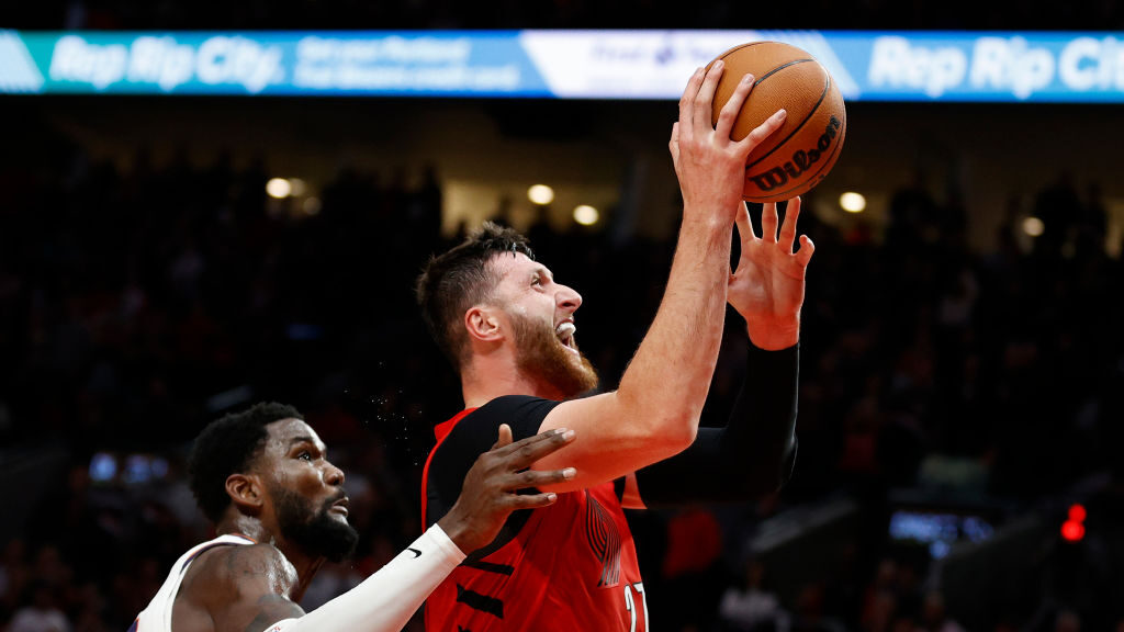 Deandre Ayton #22 of the Phoenix Suns defends Jusuf Nurkic #27 of the Portland Trail Blazers during...