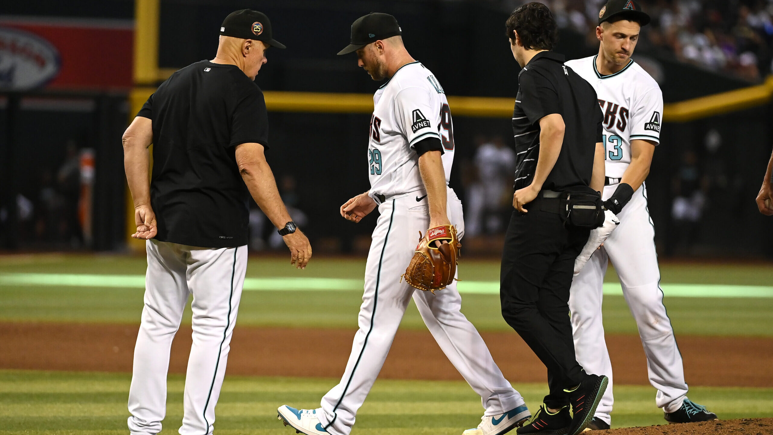 Merrill Kelly (2nd L) #29 of the Arizona Diamondbacks leaves the game during the eighth inning agai...