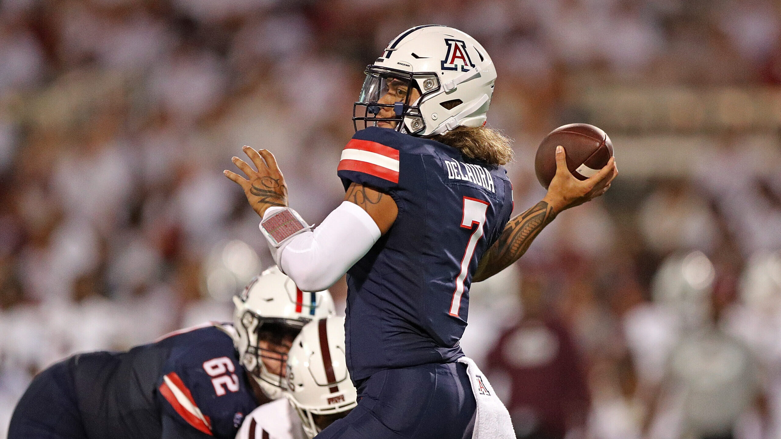 Jayden de Laura #7 of the Arizona Wildcats passes the ball during the first half against the Missis...