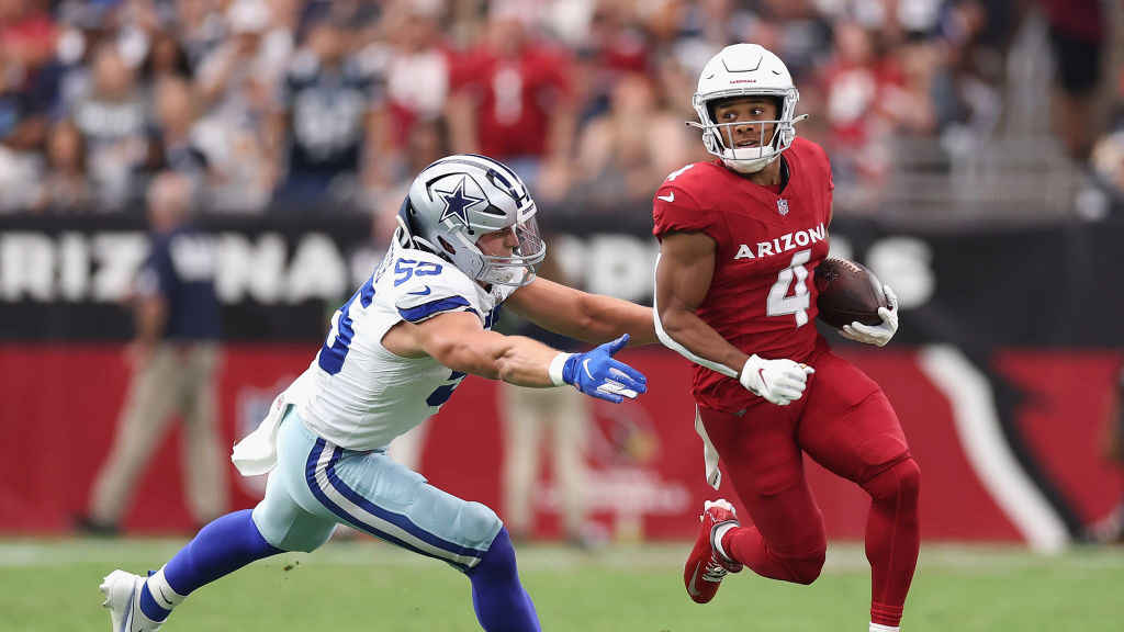 Wide receiver Rondale Moore #4 of the Arizona Cardinals runs with the football ahead of linebacker ...