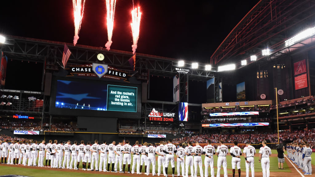 Members of the Arizona Diamondbacks stand for the National Anthem before the National League Divisi...