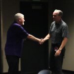 Greg Schulte, left, shakes hands with Derrick Hall, CEO and president of the Arizona Diamondbacks.