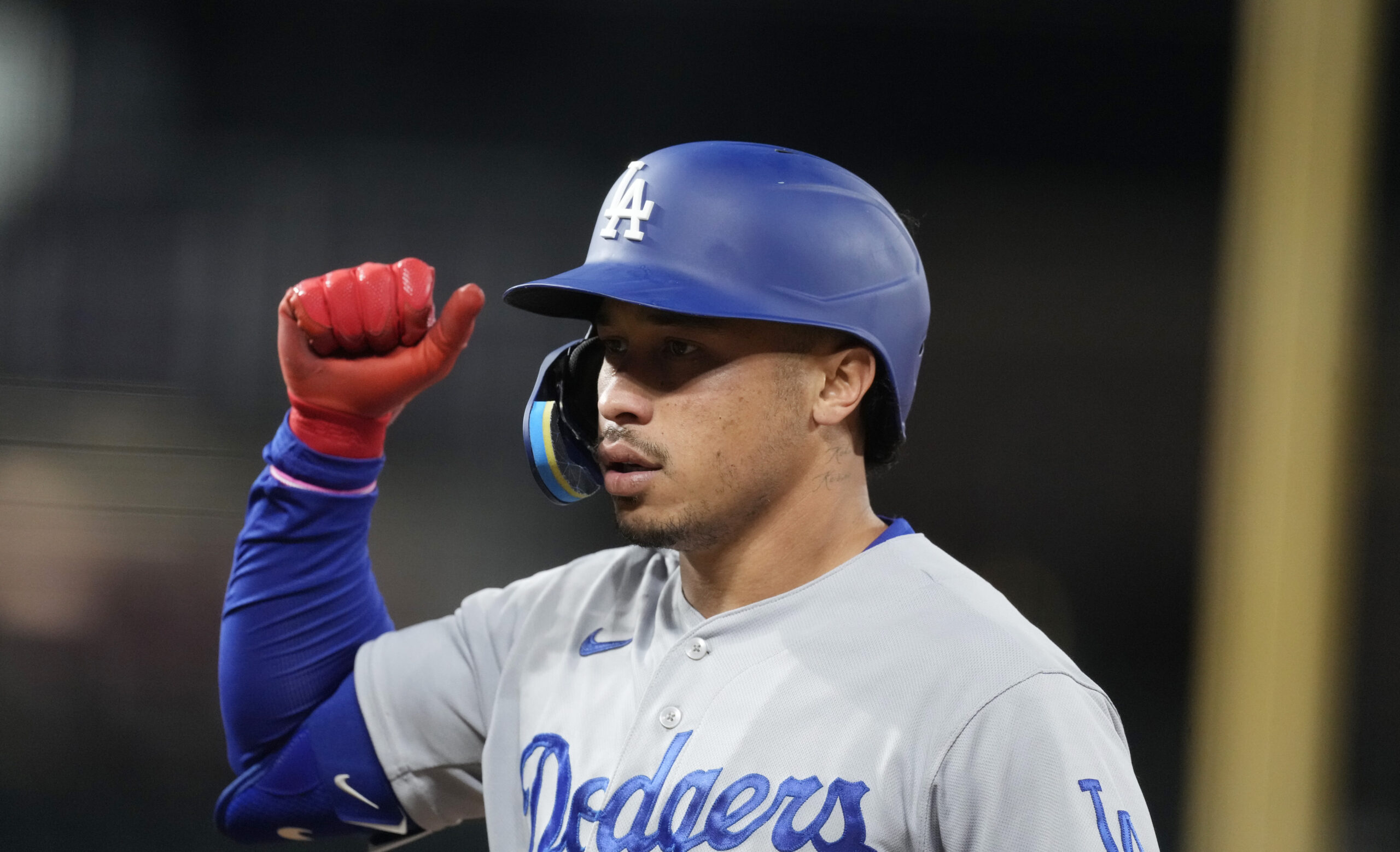Los Angeles Dodgers' Kolten Wong gestures after his RBI single off Colorado Rockies relief pitcher ...