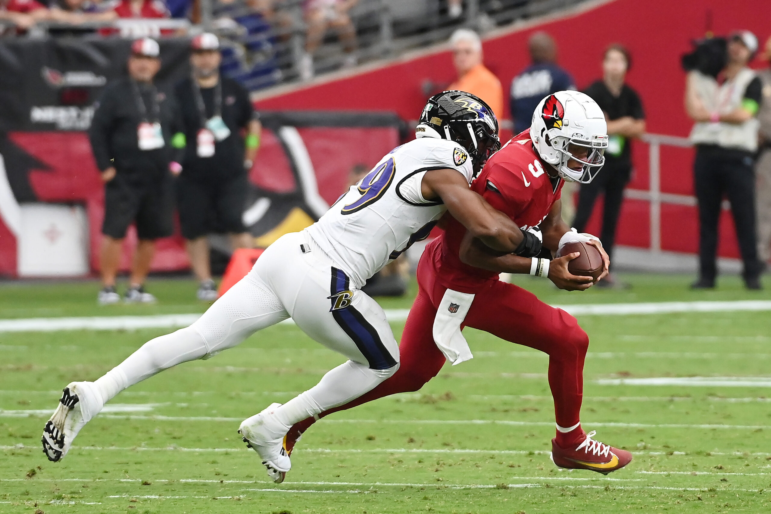 Joshua Dobbs #9 of the Arizona Cardinals is sacked during the first half against the Baltimore Rave...