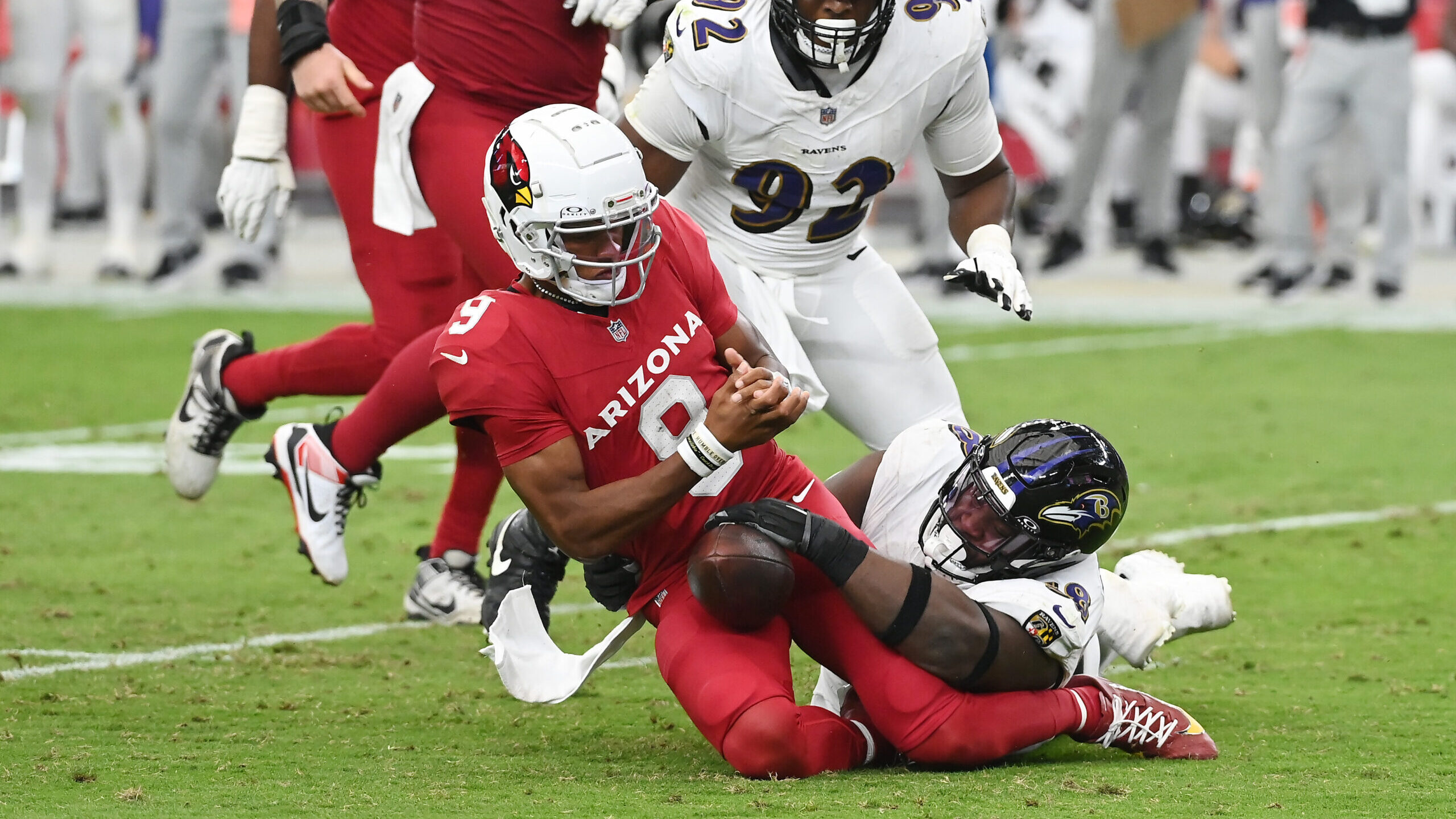 Michael Pierce #58 of the Baltimore Ravens forces a fumble by Joshua Dobbs #9 of the Arizona Cardin...