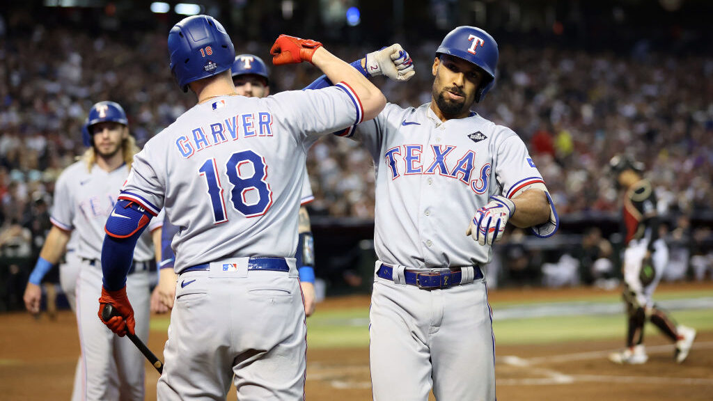 Mitch Garver #18 and Marcus Semien #2 of the Texas Rangers celebrate after Semien hit a home run in...
